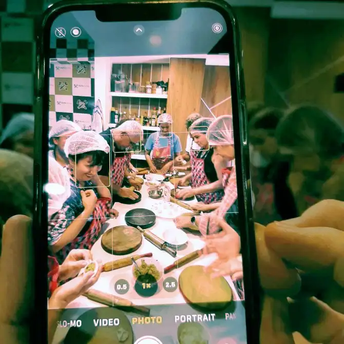 Travelers learning to make traditional Nepali momos in a SASANE cooking class in Nepal